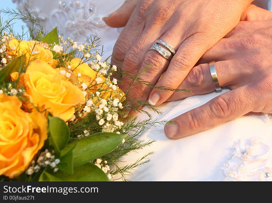 A couple showing their wedding rings. A couple showing their wedding rings