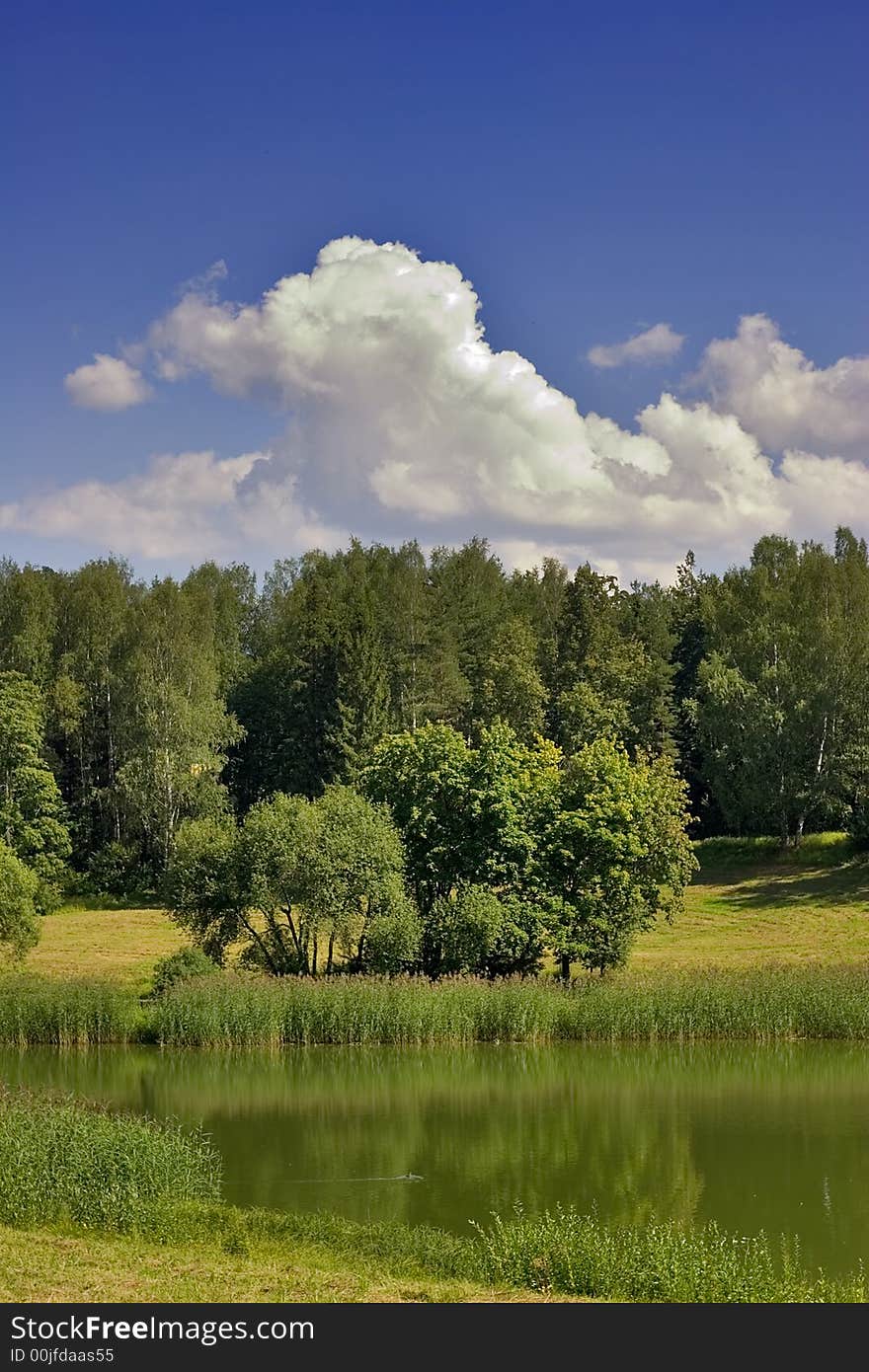 Landscape with blue sky, clouds, forest and lake. Landscape with blue sky, clouds, forest and lake