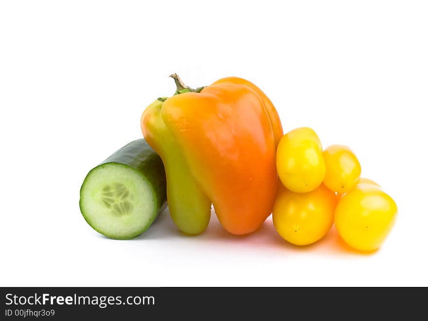 Cucumber, bell pepper and four yellow tomatoes isolated on white. Cucumber, bell pepper and four yellow tomatoes isolated on white