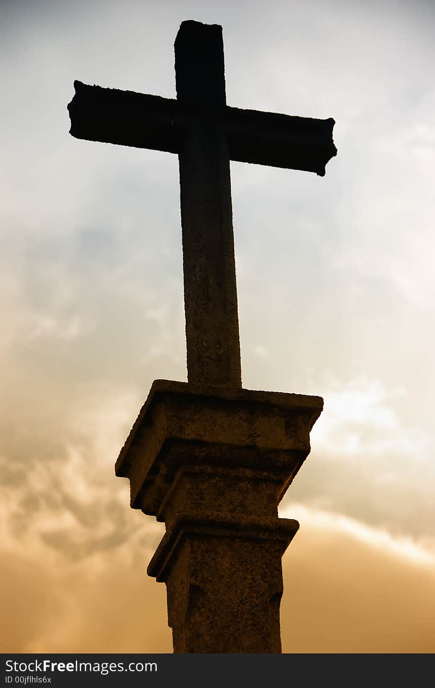 Cross silhouette and the clouds at sunset