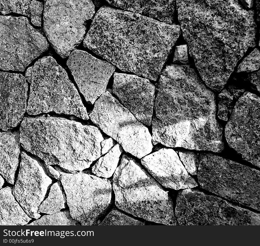 granite cut in different shapes stack to create a strong wall, people may have divided background but can have strong bonds. granite cut in different shapes stack to create a strong wall, people may have divided background but can have strong bonds