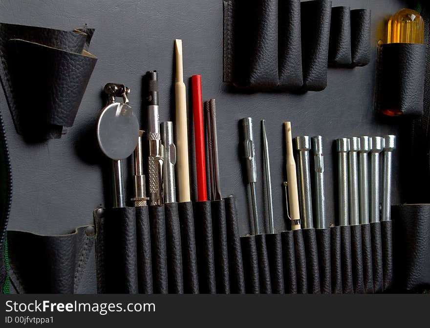 Tool kit in a bag with leather pockets close up