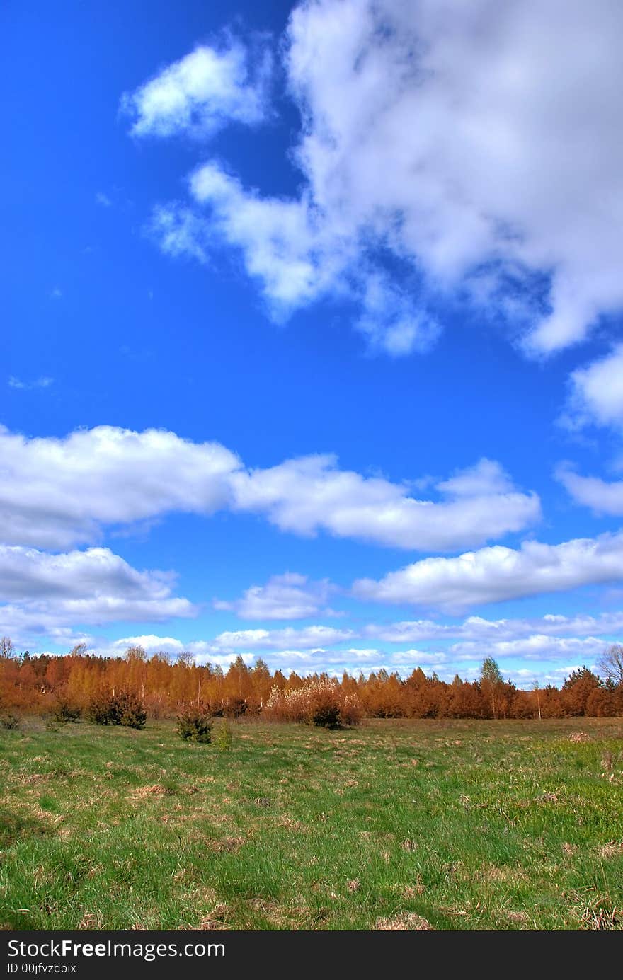 Autumn landscape with white clouds on blue sky