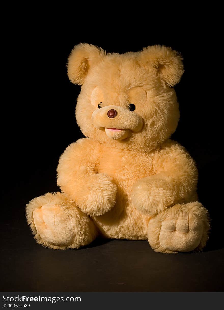 Yellow bear isolated on black. Yellow bear isolated on black