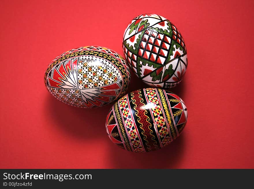 Three easter eggs isolated on red