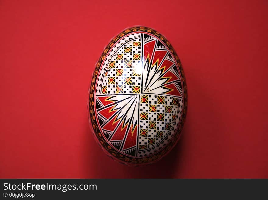 One easter egg isolated on red