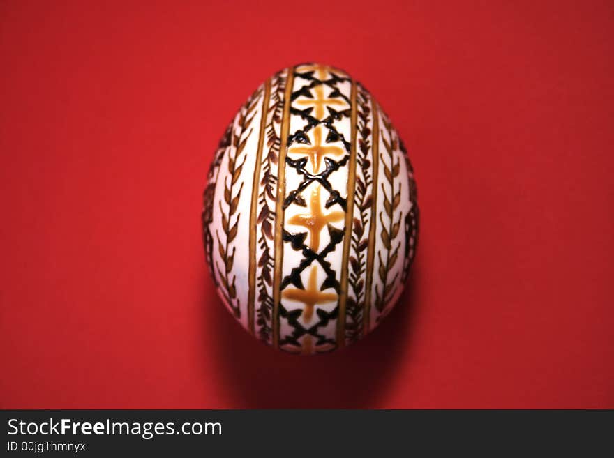 One easter egg isolated on red