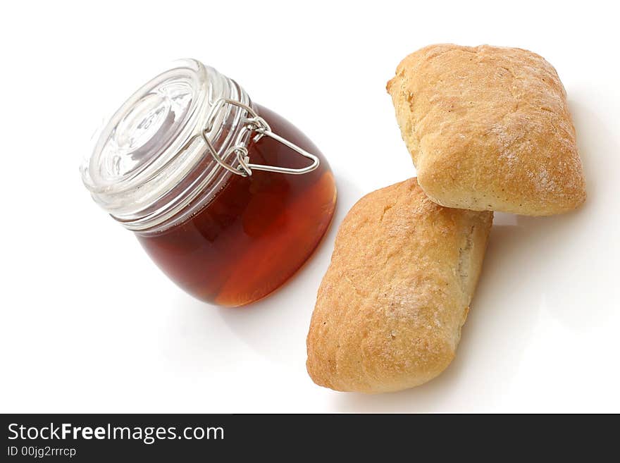 Honey and Bread rolls isolated on white