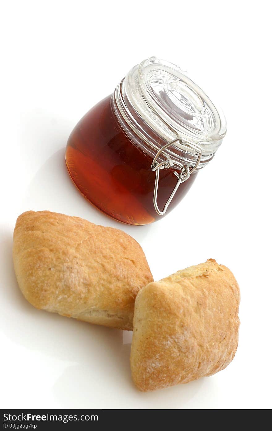 Honey and Bread rolls isolated on white