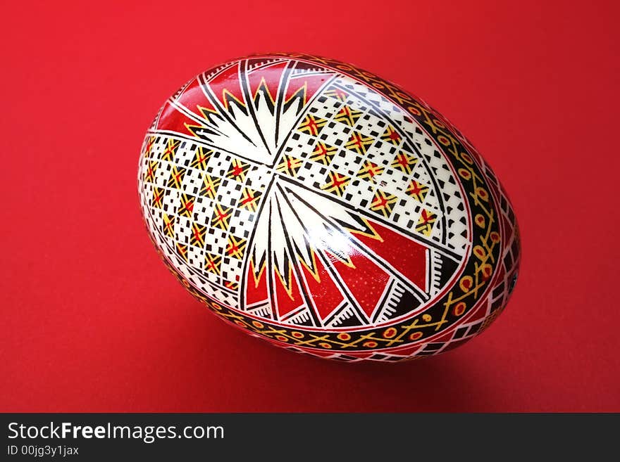 One easter egg isolated on red