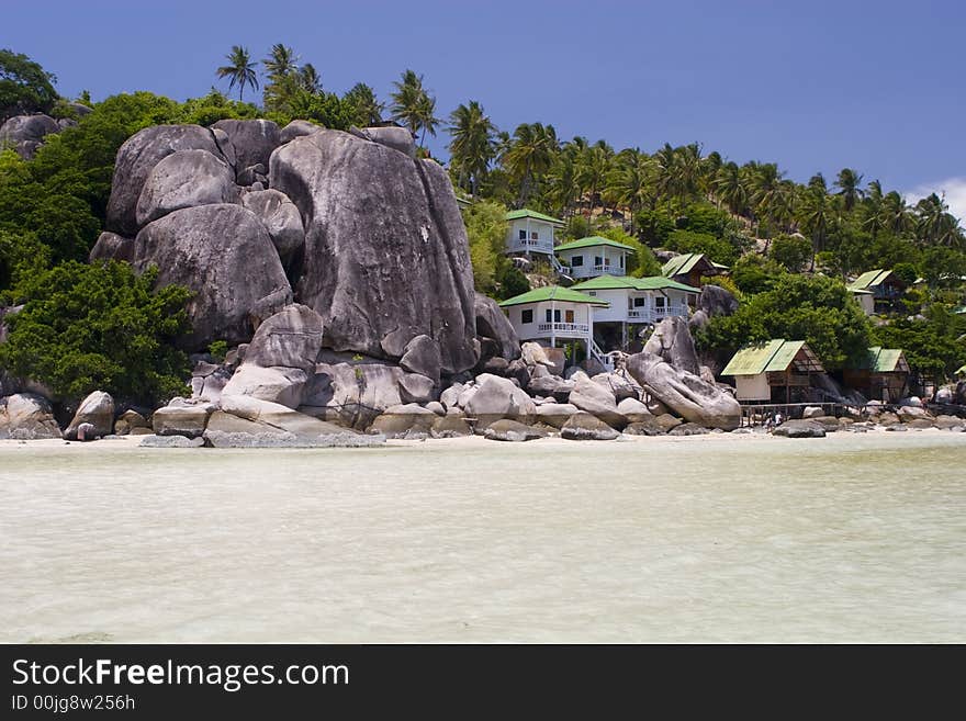 Bungalows between rocks at the thailand ocean beach. Bungalows between rocks at the thailand ocean beach