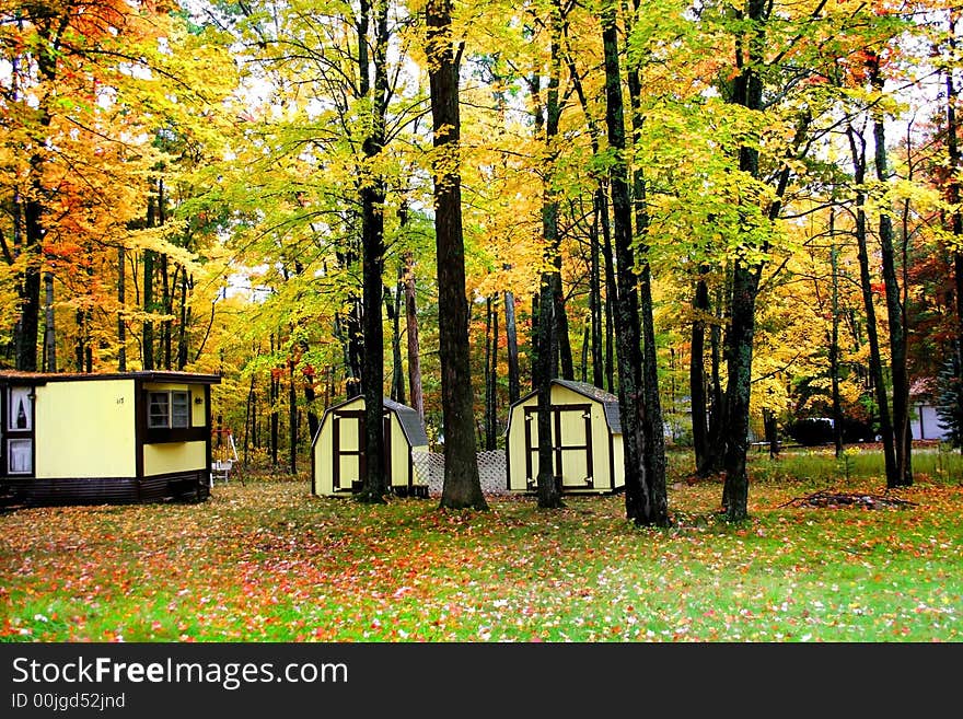 Cabins in the middle of forest during autumn time. Cabins in the middle of forest during autumn time.