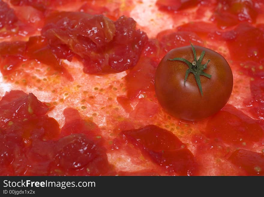 Single tomato on squeezed tomato. Single tomato on squeezed tomato