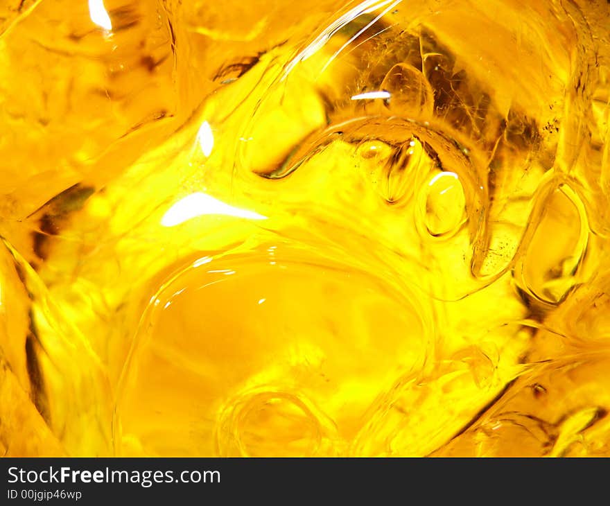 Close-up of ice cubes floating in yellow beverage. Close-up of ice cubes floating in yellow beverage.