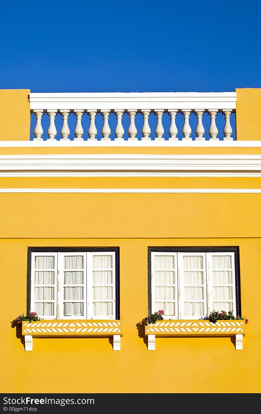 Bright yellow building with square windows. Bright yellow building with square windows