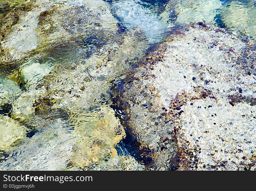 Background picture of reefs washed by the sea wave