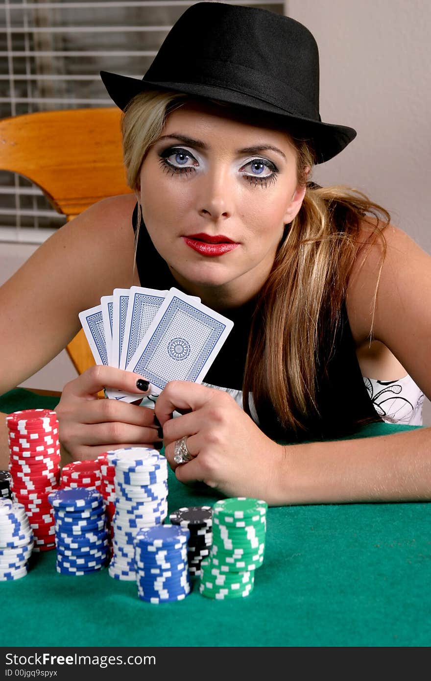 Colorful portrait of woman in a black hat with cards and gambling chips. Colorful portrait of woman in a black hat with cards and gambling chips.