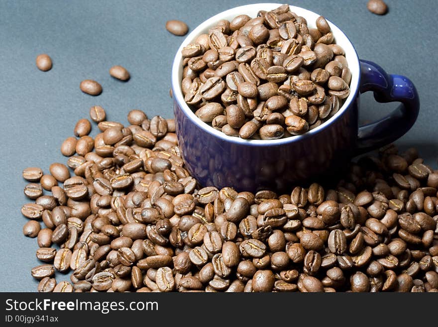 The beans in cup on coffee