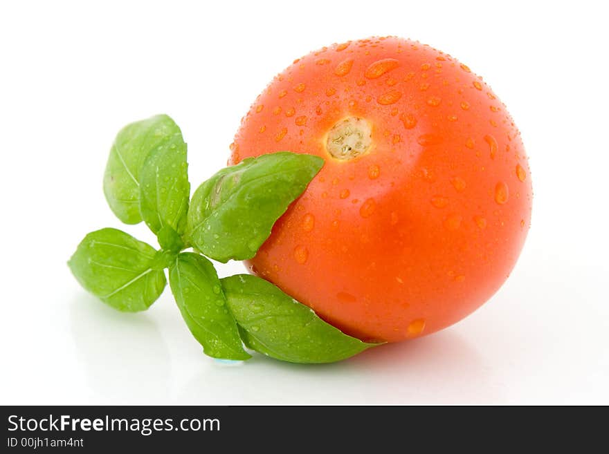 Tomato with basil isolated over white background. Tomato with basil isolated over white background