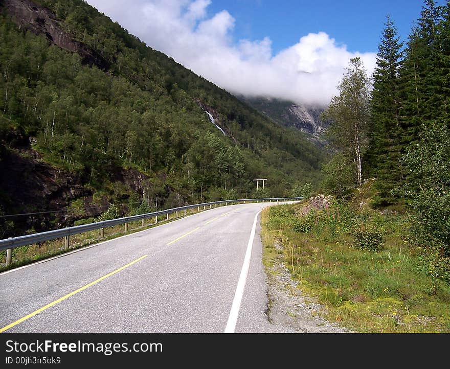 Norway, asphalt road between trees covered mountains.

<a href='http://www.dreamstime.com/beauty-of-norway-rcollection5045-resi208938' STYLE='font-size:13px; text-decoration: blink; color:#FF0000'><b>BEAUTY OF NORWAY COLLECTION »</b></a>. Norway, asphalt road between trees covered mountains.

<a href='http://www.dreamstime.com/beauty-of-norway-rcollection5045-resi208938' STYLE='font-size:13px; text-decoration: blink; color:#FF0000'><b>BEAUTY OF NORWAY COLLECTION »</b></a>