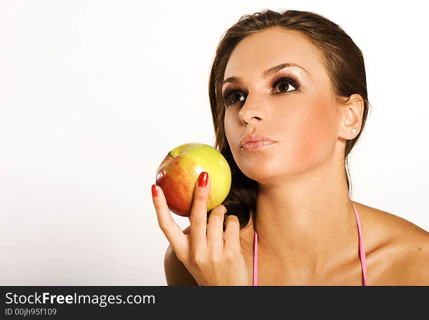 A beautiful woman holding a red apple. A beautiful woman holding a red apple