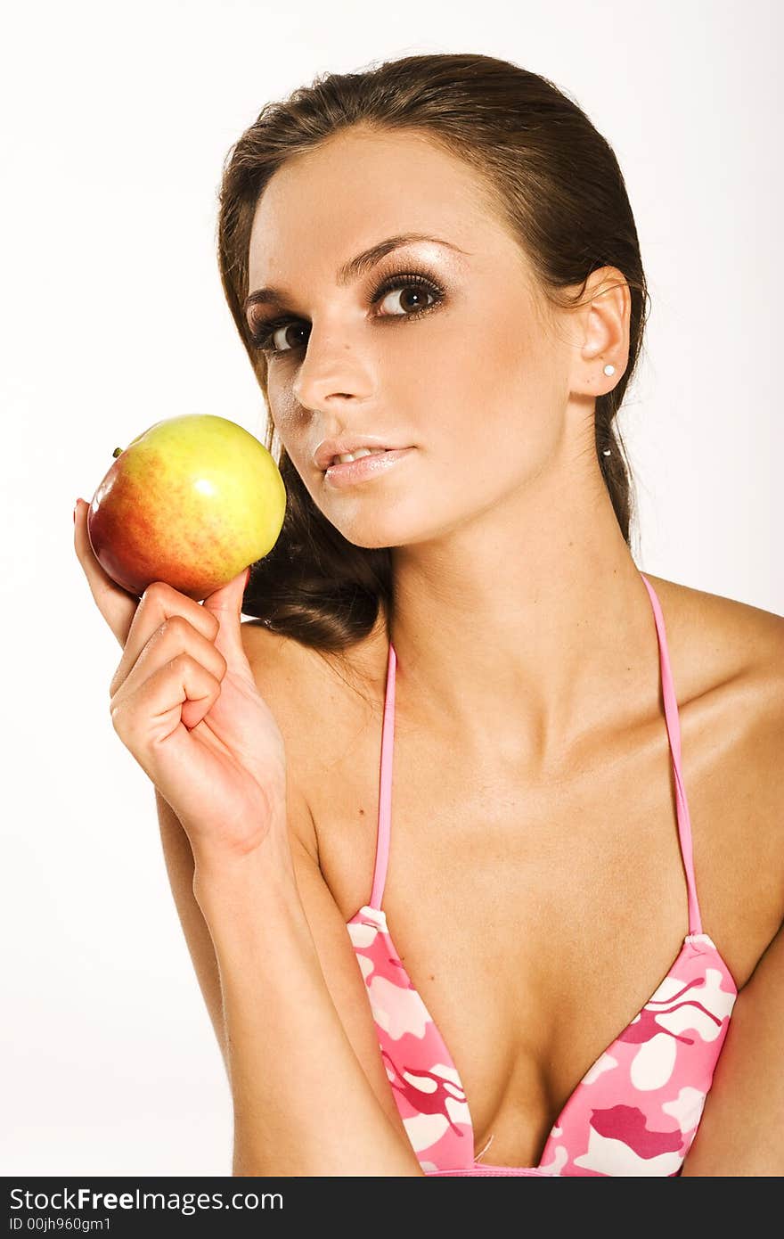 A beautiful woman holding a red apple. A beautiful woman holding a red apple