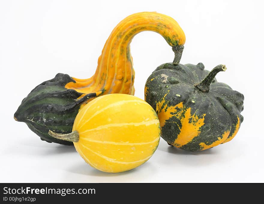 Three colorful pumpkins on white background