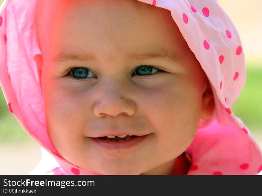 Lovely little baby in the spotted pink scarf. Lovely little baby in the spotted pink scarf