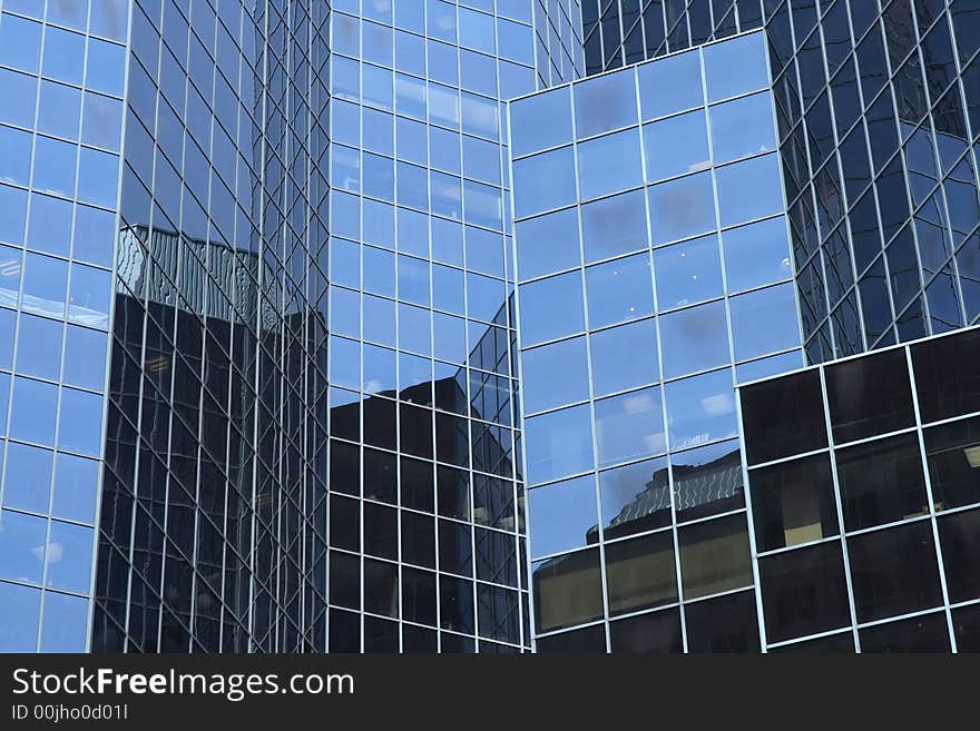 Reflections in a modern glass-windowed office building. Reflections in a modern glass-windowed office building.