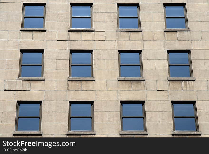 Blue windows of a modern stone building. Blue windows of a modern stone building.