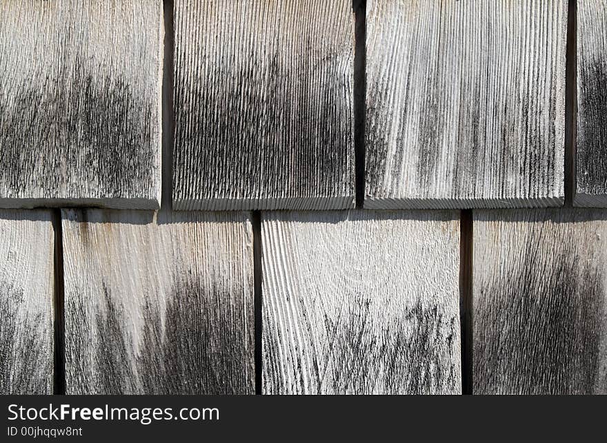 Gray wooden tiles background. Detail of a house wall.