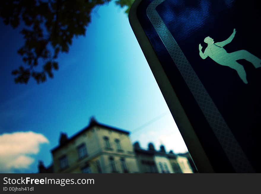 Traffic sign with a sticker of a man doing taishi. Traffic sign with a sticker of a man doing taishi