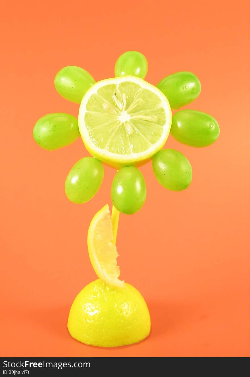 Creative food: fruits flower on orange background