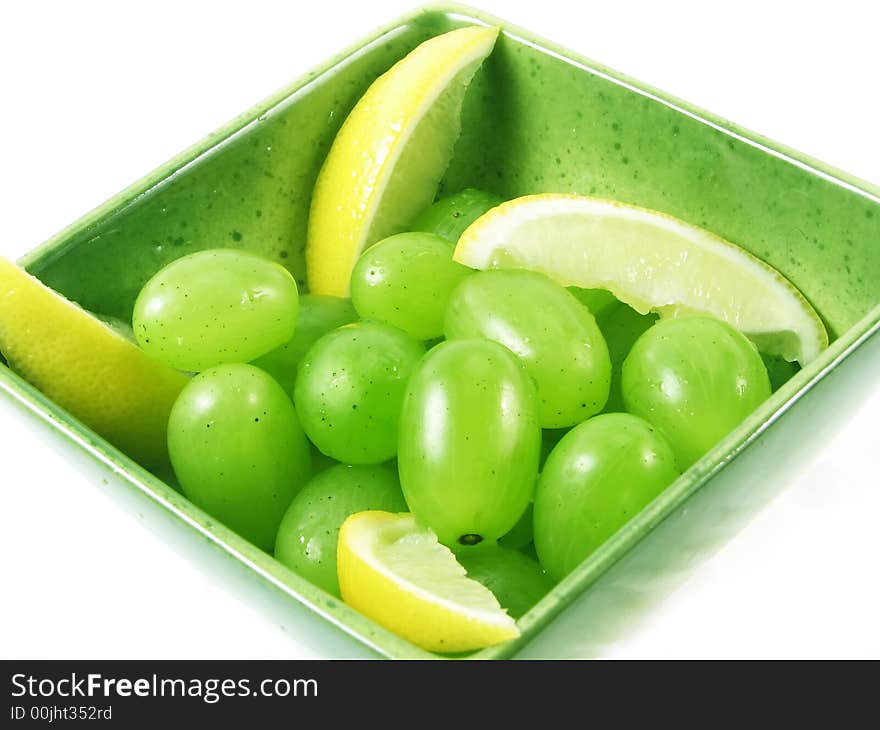 Grapes fruit in green bowl on white background