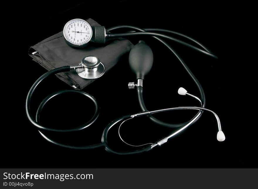 Sphygmomanometer and stethoscope taken on black cloth. Sphygmomanometer and stethoscope taken on black cloth