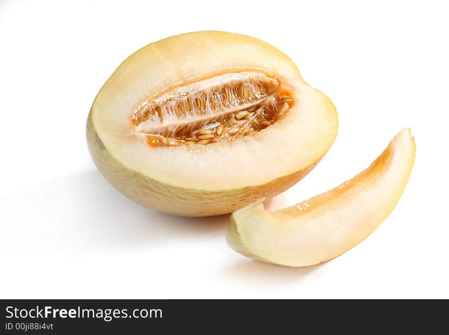 Ripe yellow melon and slice isolated over white. Ripe yellow melon and slice isolated over white