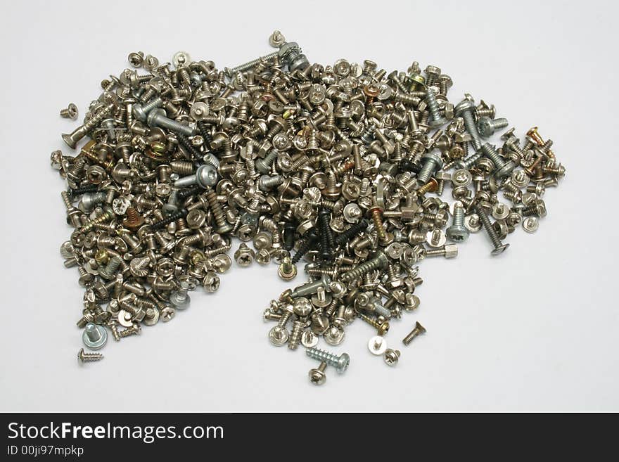 Pile of assorted metal screws on white background. Pile of assorted metal screws on white background