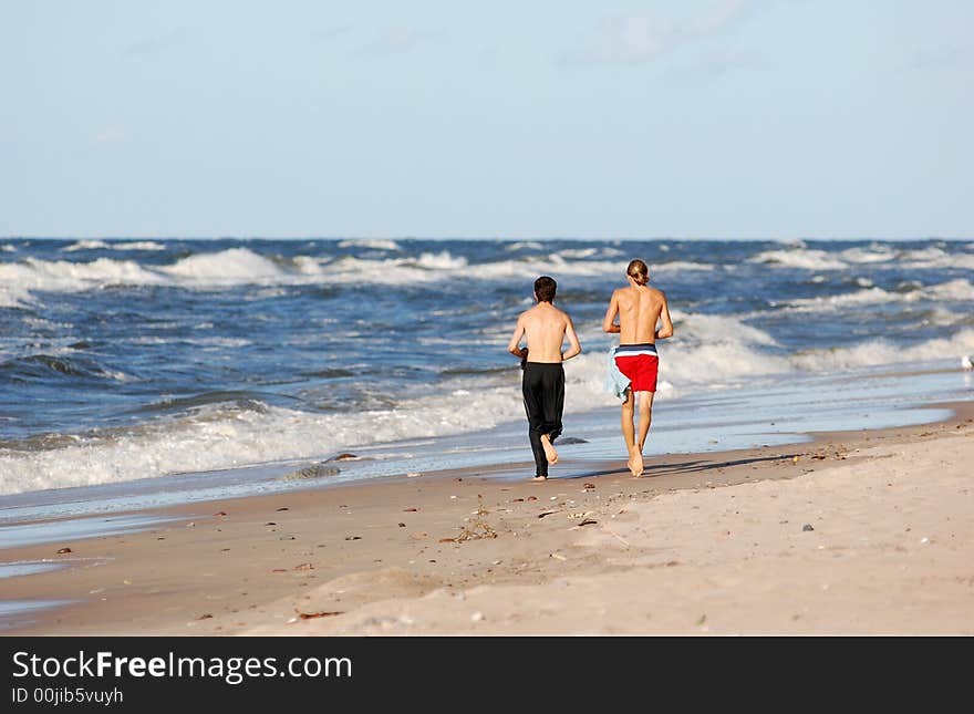 Boys running on the beach