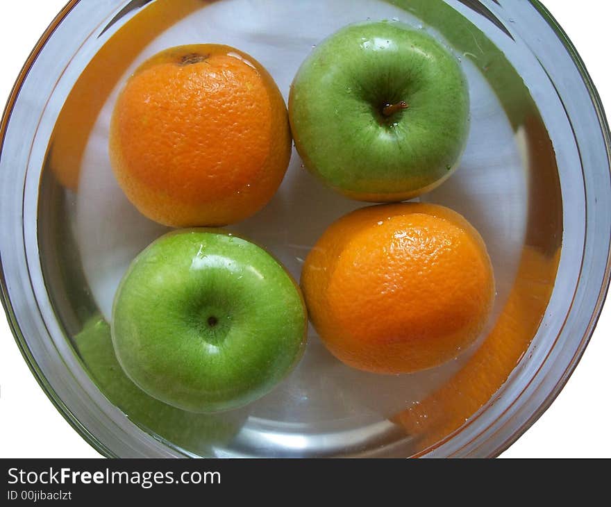 Apple and orange washing in glass plate. Apple and orange washing in glass plate