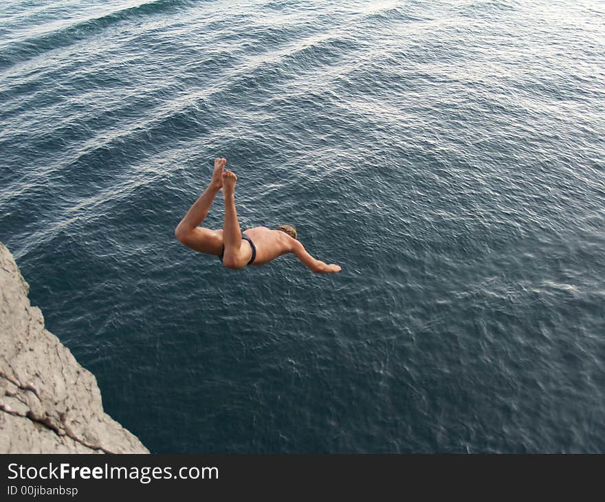 Boy jumping to the sea