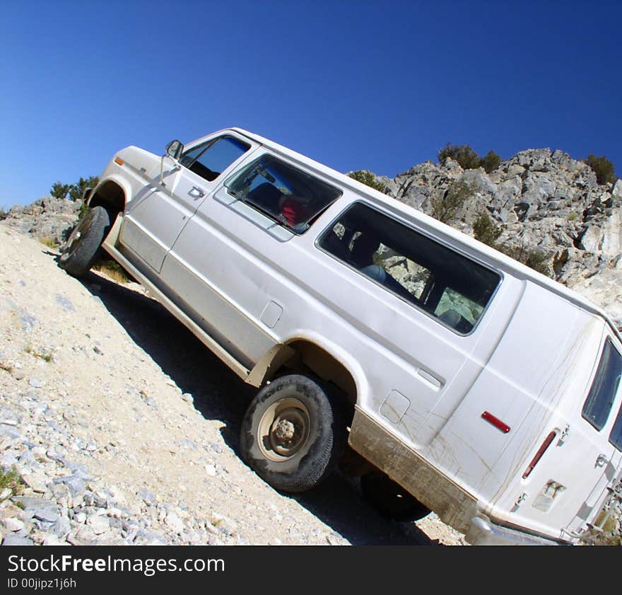 4x4 van on steep incline, exaggerated camera angle. 4x4 van on steep incline, exaggerated camera angle