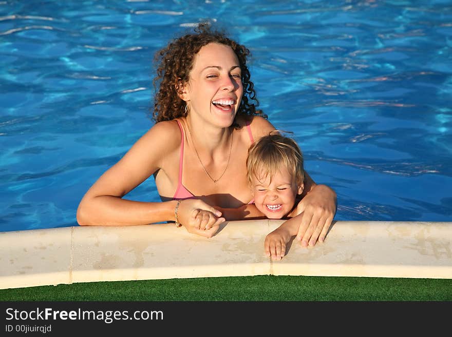 Mother with the child in the pond