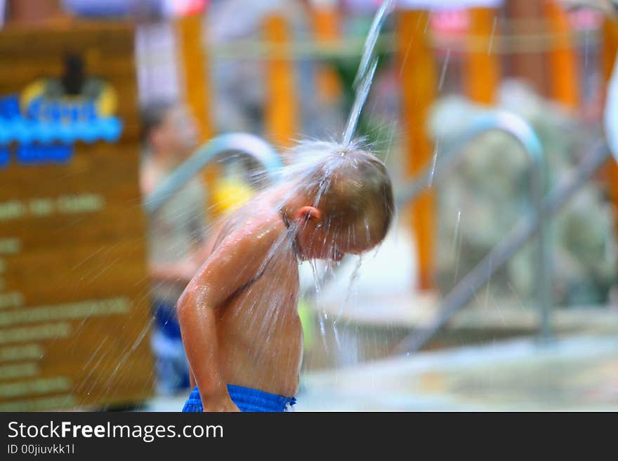 Boy in water park playing with water