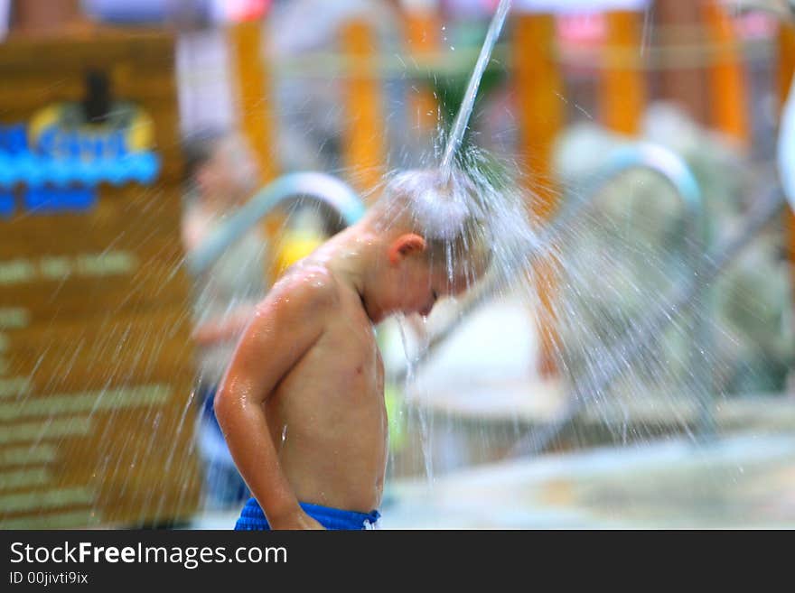 Boy in water park playing with water