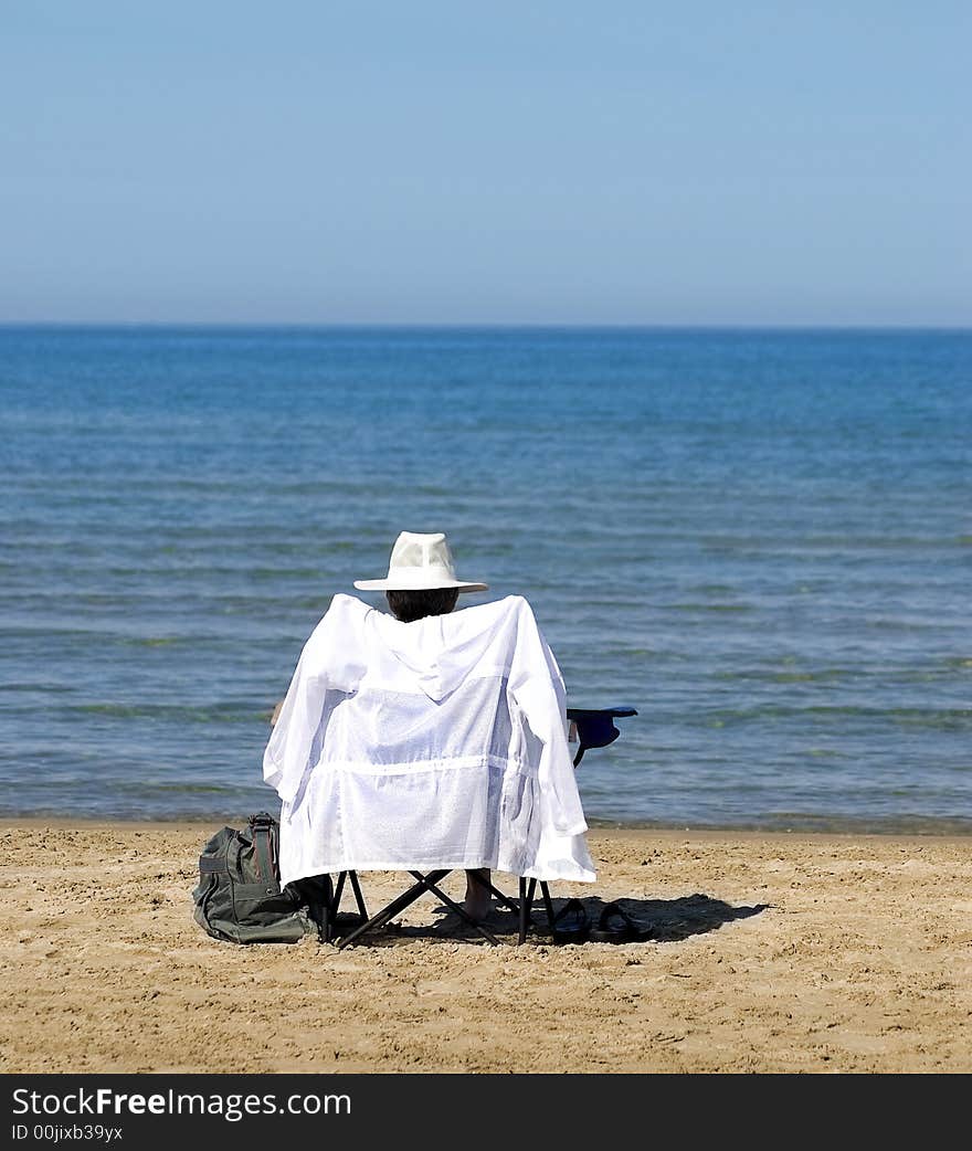 Woman relaxing and sunning on the beach. Woman relaxing and sunning on the beach