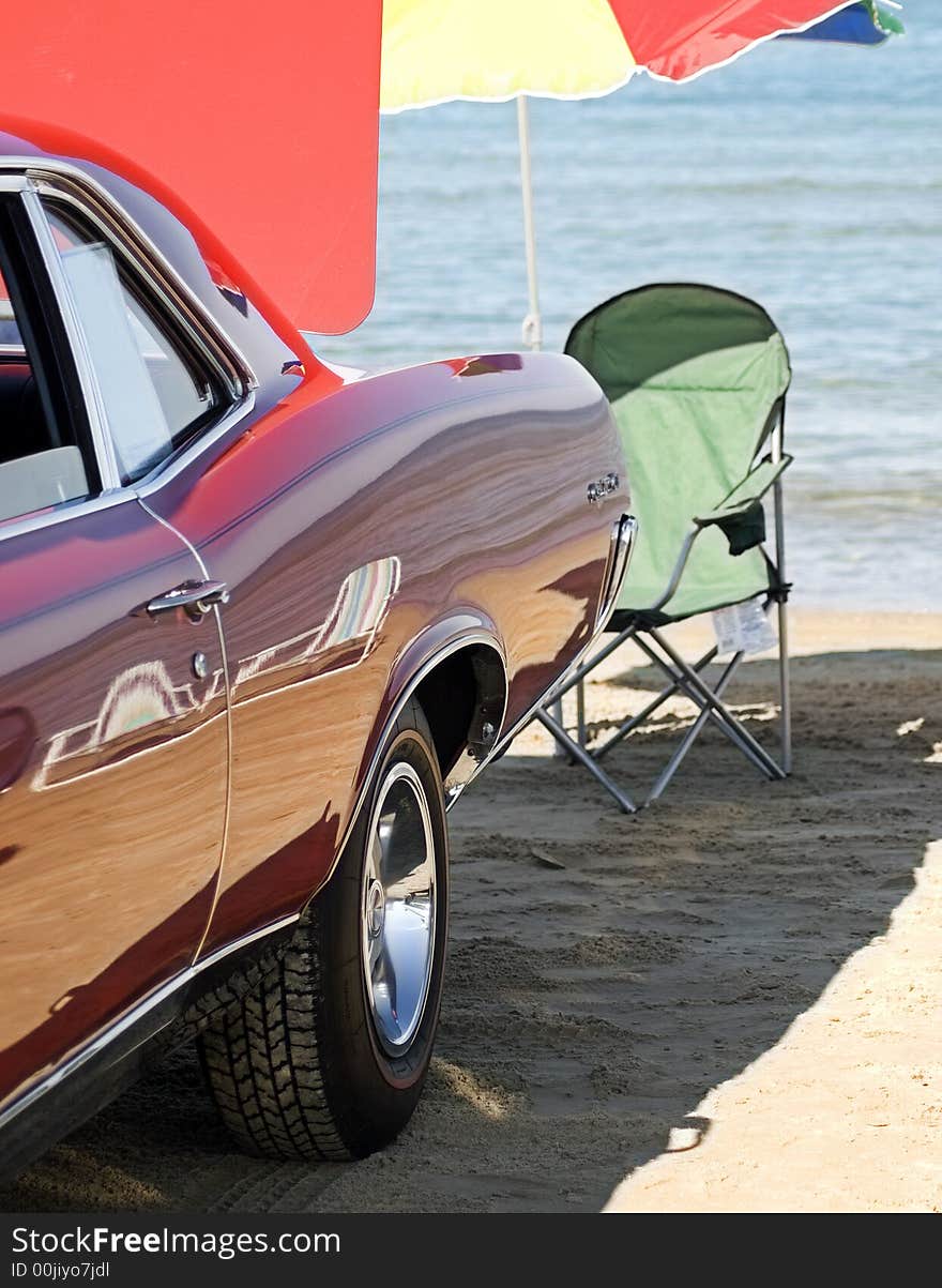 Beach chair, umbrella and classic car on the shore. Beach chair, umbrella and classic car on the shore