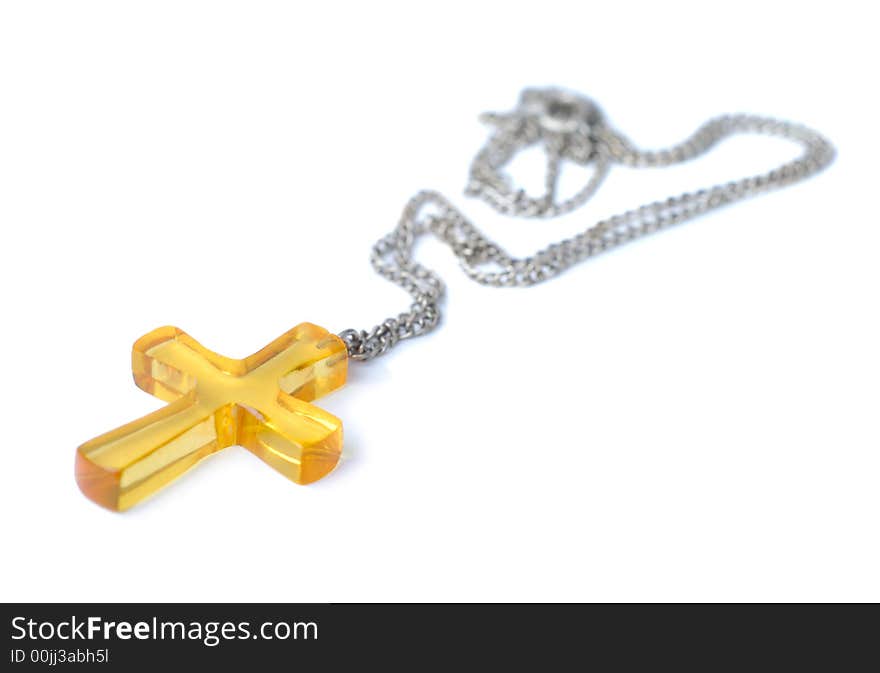 Amber cross with small chain isolated over white background