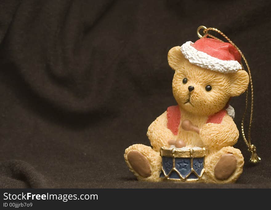 Small bear figure on christmas dressing over black background. Small bear figure on christmas dressing over black background