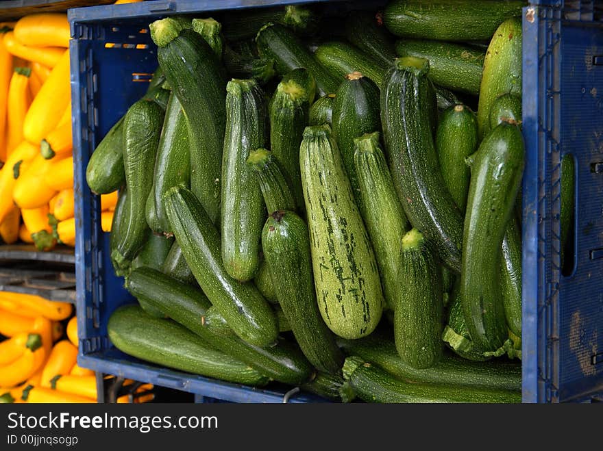 Green and yellow squash in bins at market. Green and yellow squash in bins at market