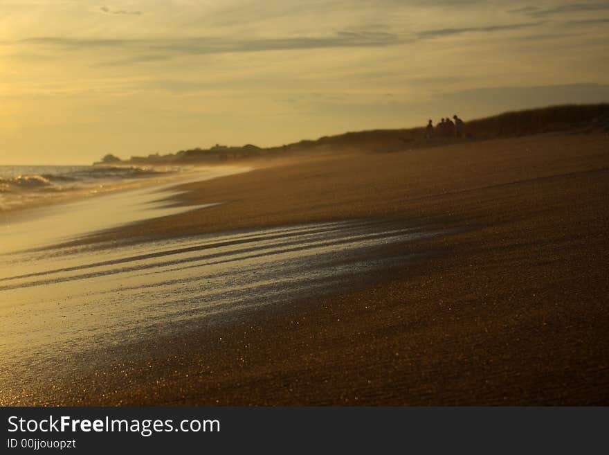 An ocean wave with the focus on the sand in front. An ocean wave with the focus on the sand in front